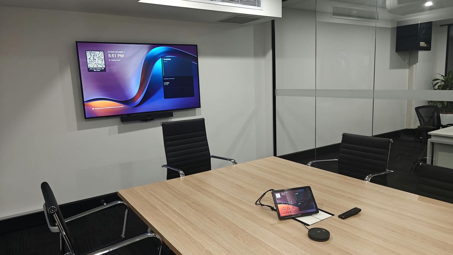 Boardroom video conferencing screen and camera installed by COMPwize