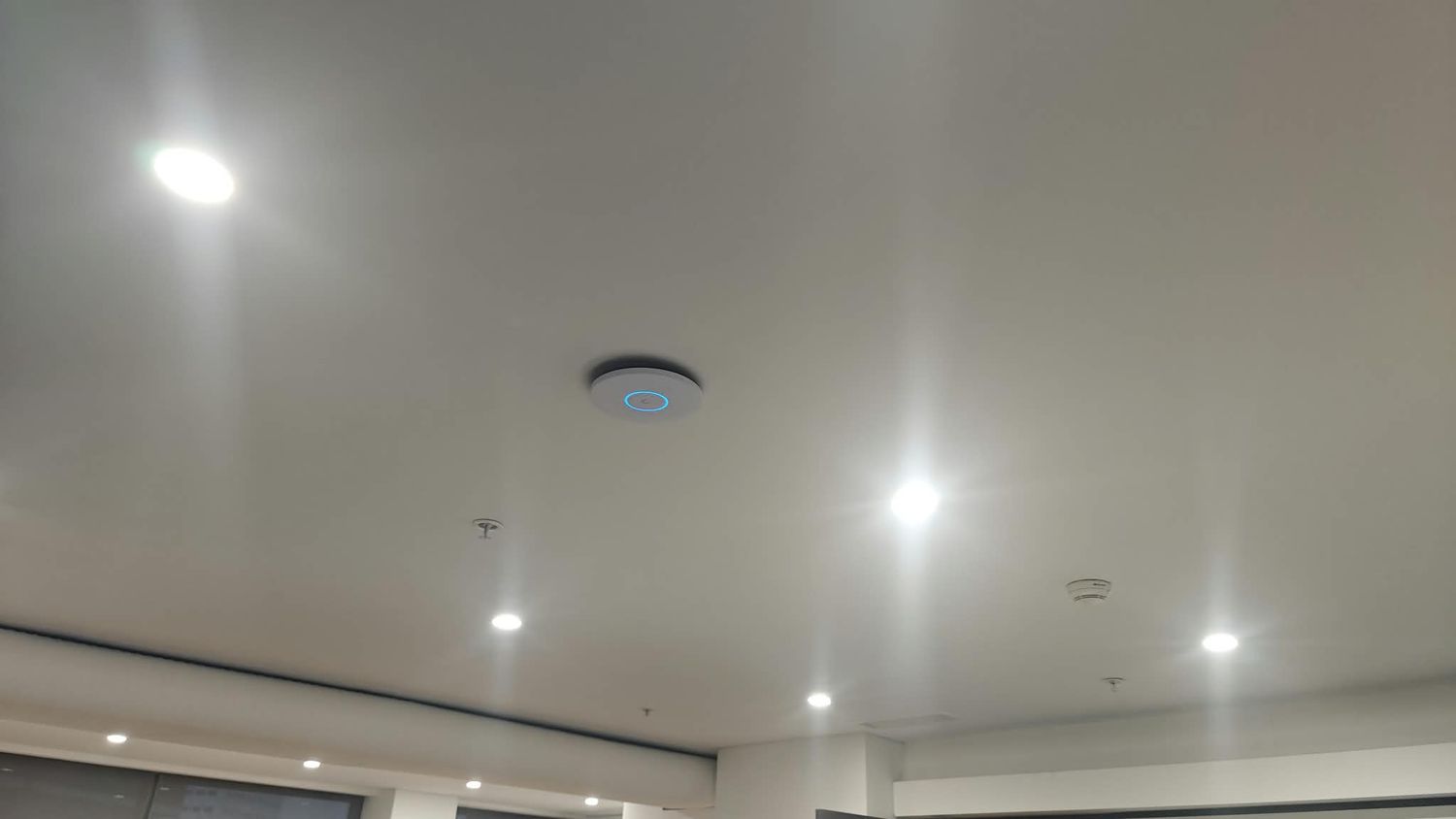 Ceiling-mounted business Wi-Fi access point installed in an office