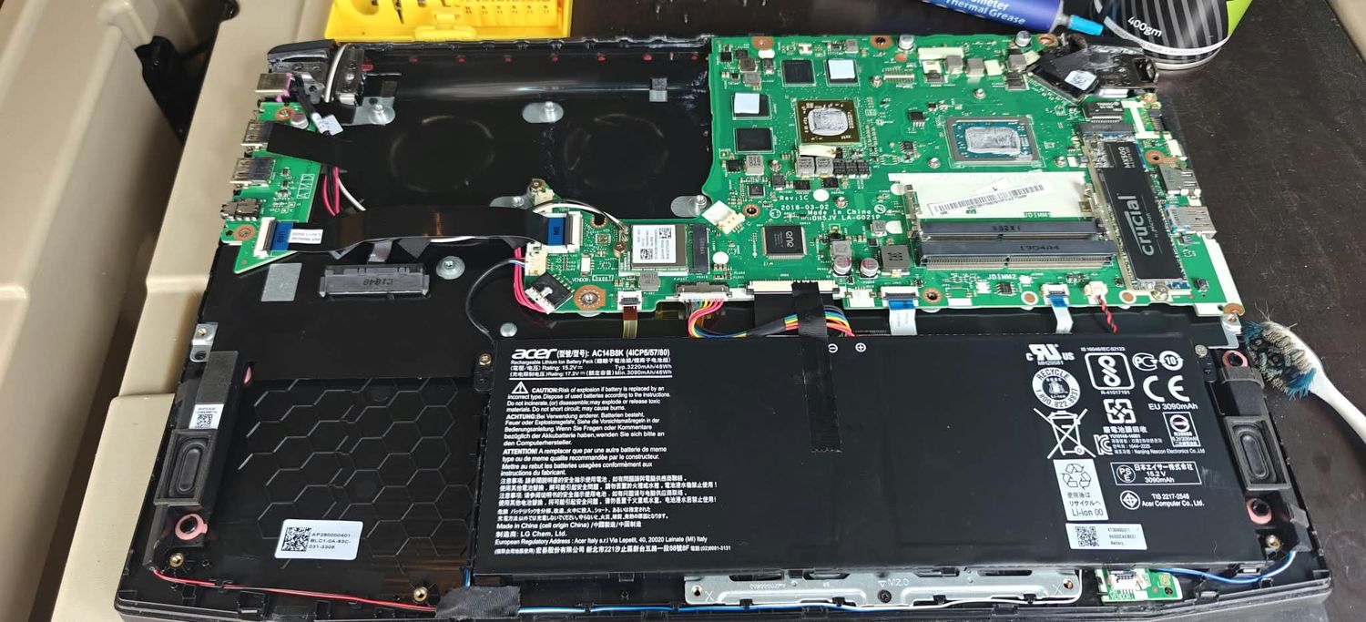 Laptop battery and SSD replacement in progress