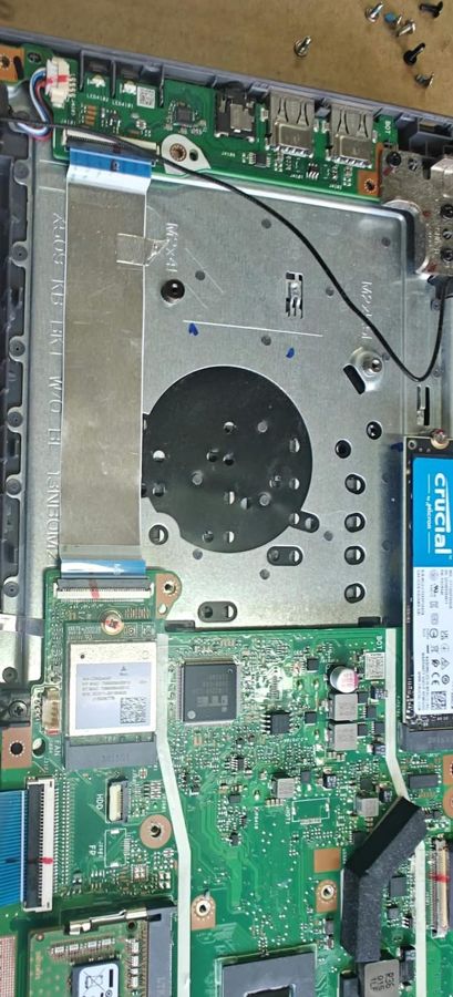 A Crucial SSD fitted to an Asus laptop during an upgrade