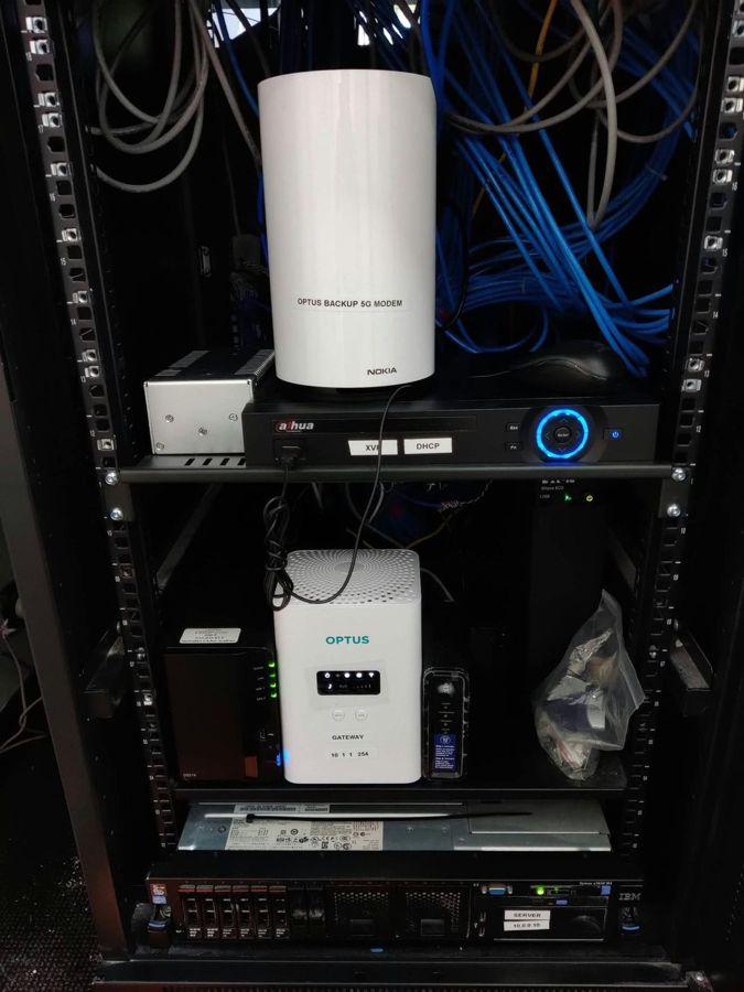 Business internet gateway with 5G failover modem and NAS backup in a comms rack