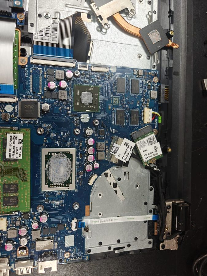 Laptop motherboard with fresh thermal paste applied to the processor