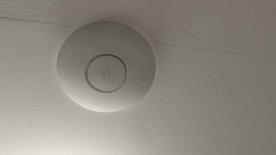 Ceiling-mounted Wi-Fi access point installed by COMPwize